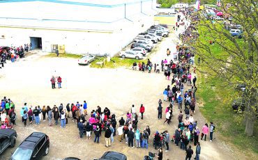 The Bread and Cheese line snaked around the arena to the road. ( Photo by Jim C Powless)