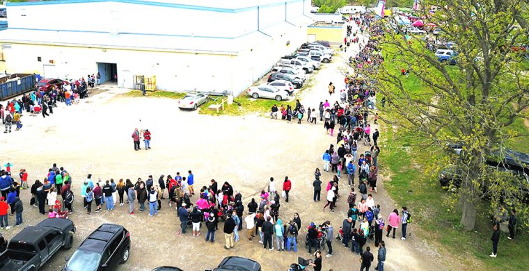 The Bread and Cheese line snaked around the arena to the road. ( Photo by Jim C Powless)