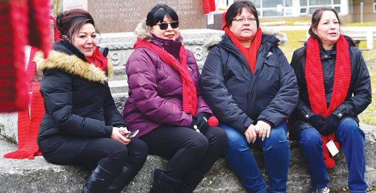 (Left to Right) Debra Jonathan, Ellie Hill, Kim Logan, Paula Maracle. Red Scarf Day organizers from Six Nations Health Services spent time out in the cold decorating Veterans Park with 188 red scarves. (Photo by Jim C Powless)