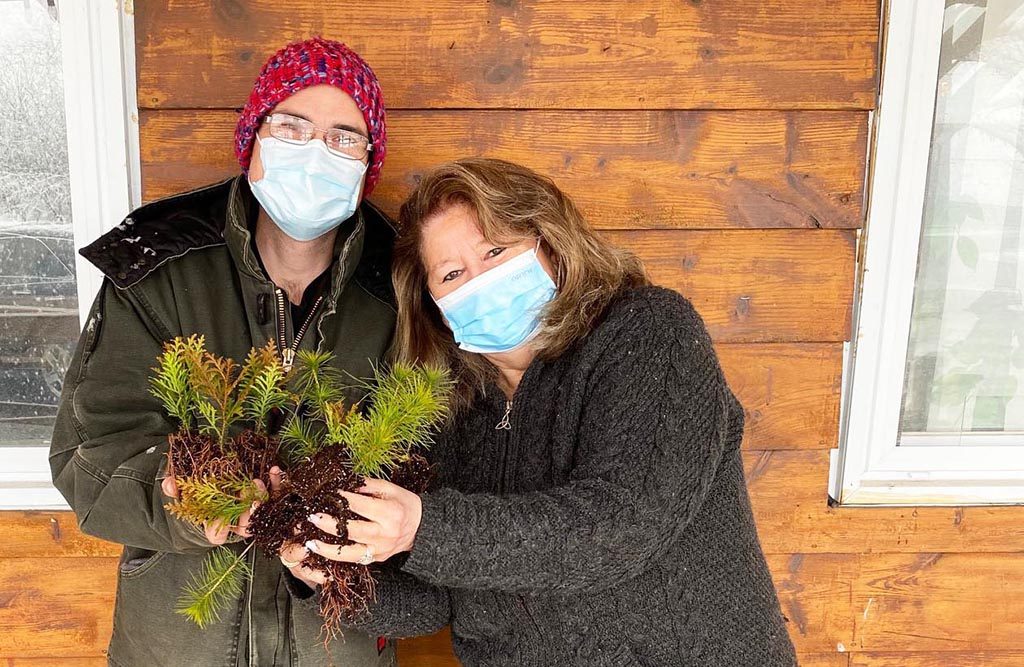 THE TREES HAVE ARRIVED!!!!! Turtle Island News publisher Lynda Powless and St Williams Nursery’s Gerry Birnstiel, Shipping Manager show off the pines and white cedars that will be among the trees given away Earth Day, Friday April 22 at Turtle Island News from 10 a.m. to 4 p.m. Don’t forget to drop by!