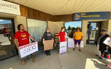 A peaceful demonstration was held outside the bank in Ohsweken to draw attention to corporate banks funding pipelines. (Photo by Jim C.Powless)