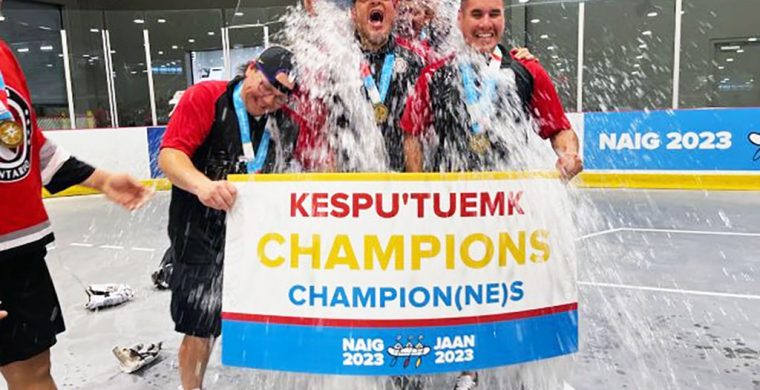Darcy Powless (on left) and other Team Ontario coaches get a celebratory soak after winning a gold medal at the North American Indigenous Games. (Photo courtesy Darcy Powless.)