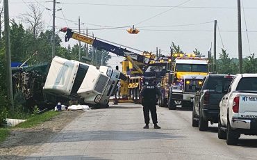 Six Nations Police had their hands full when a transport truck overturned at Fifth Line turning onto Chiefswood Road Monday (July 17) holding up traffic for most of the day. (Photo by Jim C. Powless)