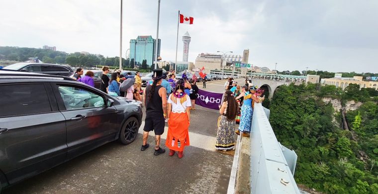 The 96th annual IDLA Border Crossing marking Indigenous rights to cross the international line stopped in the middle of the Rainbow Bridge to hold ceremonies, as they headed from Niagara Falls N.Y. to Niagara Falls, Ont., Saturday. (Supplied Photo)