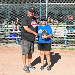 Tournament organizer Darrell Anderson presents Mohawks’ player Ginny Smith with a new glove for being the MVP in the women’s masters category at the All Ontario Native Fastball Tournament. Photo courtesy Audrey MacDonald.