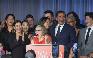 Manitoba Premier Elect Wab Kinew is surrounded by family as he makes history as Canada’s first Indigenous premier. (CP Photo)