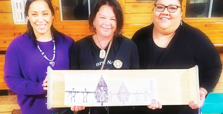 Kelly Back, Dawn Iehstoseranónnha and Samantha Doxtator with the Tsiokonsaseh Belt at the Kahnawake, Mohawk Trail Longhouse (photo by Dawn Iehstoseranónnha)