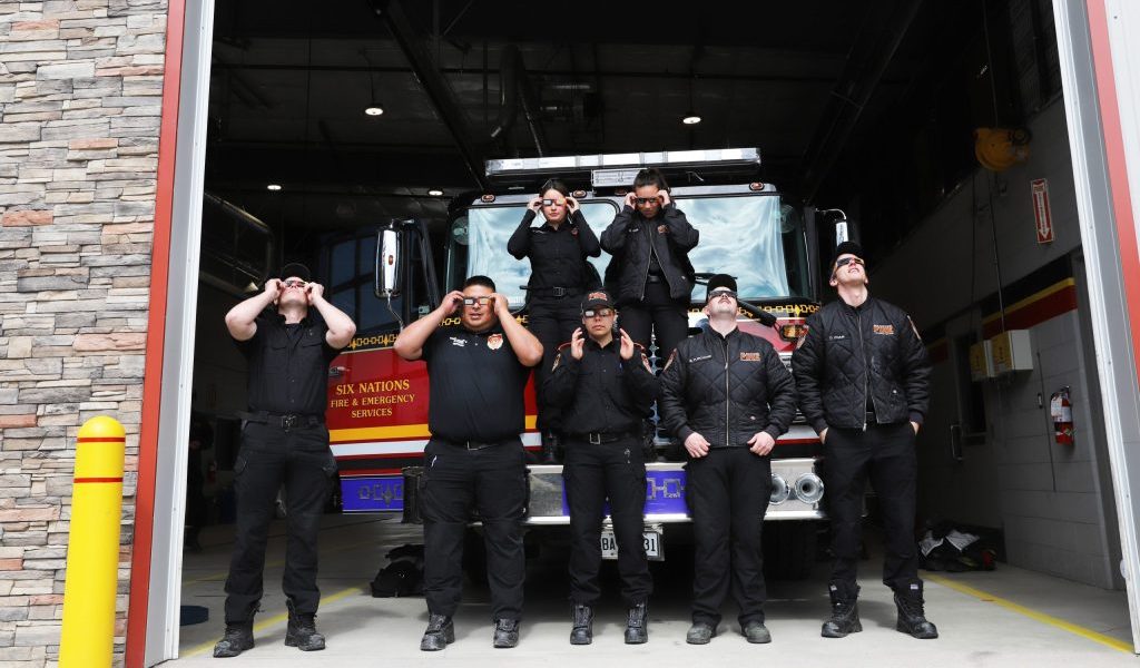 Six Nations Fire Fighters put on approved eclipse glasses to promote safety during Monday’s solar eclipse. (Photo by Jim C. Powless)