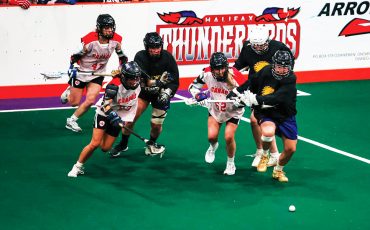 The Haudenosaunee Nationals, seen here in dark jerseys in an exhibition game against Canada earlier this month, will compete in the inaugural world women’s box lacrosse tournament in Utica this September. Photo courtesy Haudenosaunee Nationals.