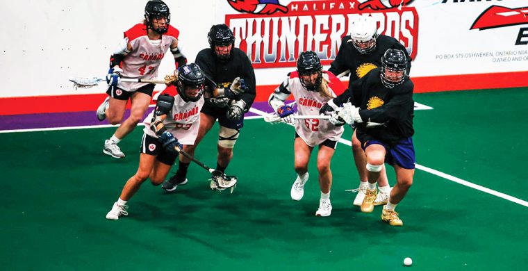 The Haudenosaunee Nationals, seen here in dark jerseys in an exhibition game against Canada earlier this month, will compete in the inaugural world women’s box lacrosse tournament in Utica this September. Photo courtesy Haudenosaunee Nationals.