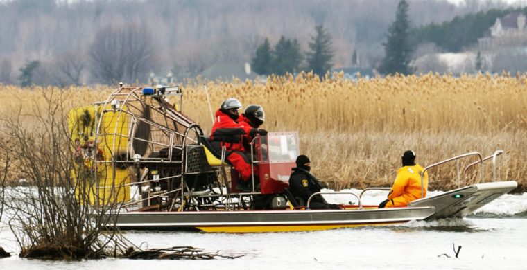 Searchers look for victims Friday, March 31, 2023 after a boat capsized and left six people dead and one infant missing in Akwesasne, Que. (Ryan Remiorz, The Canadian Press). (Canadian Press Photo)