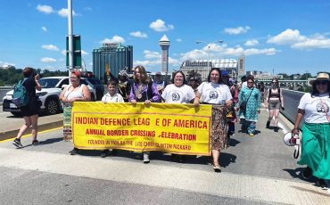 The Indian Defence League of America took to the Rainbow Bridge in Niagara Falls, Ontario Saturday marking Indigenous Border Crossing rights walking across to Niagara Falls NY. (Photo by January Rogers) ... page 2
