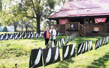 Mohawk Institute survivor Sherlene Bomberry and Survivors’ Secretariat Outreach Lead Misty Ladd stand among a display commemorating the children who died attending the Mohawk Residential School. See story and photos inside our special edition. (Photo by Austin Evans)