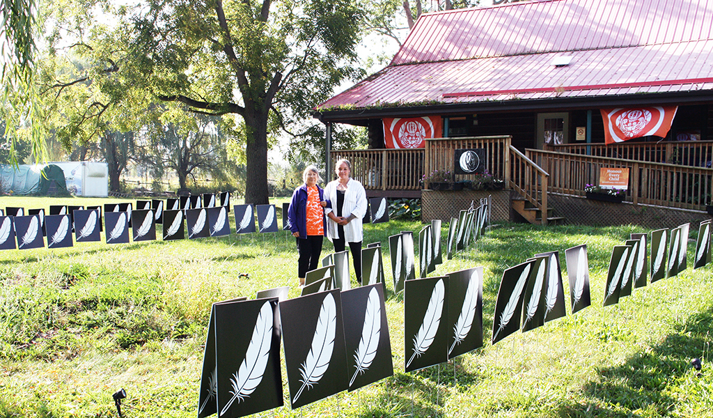 Mohawk Institute survivor Sherlene Bomberry and Survivors’ Secretariat Outreach Lead Misty Ladd stand among a display commemorating the children who died attending the Mohawk Residential School. See story and photos inside our special edition. (Photo by Austin Evans)