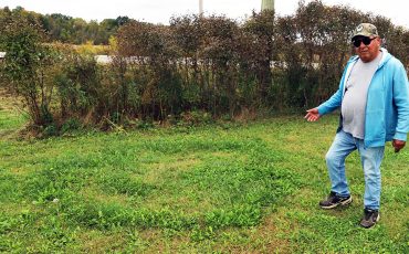 Fred Clause spots one of several “Fairy Circles” on his property. (Photo by Jim C. Powless)