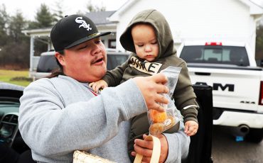 No:ia, No’:yah! Six Nations community members like Colton and Oaklin Martin joined in welcoming 2025 with the traditional New Year welcome visiting family and friends and receiving a donut at the door. (Photo by Jim C. Powless)