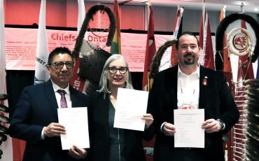 The Ontario region-specific final Child Welfare agreement is worth $8.5 billion over nine years beginning in 2025-26. The deal was signed last week by Nishnawbe Aski Nation Grand Chief Alvin Fiddler, (left), Minister of Indigenous Services Canada Patty Hajdu and Ontario Regional Chief Abram Benedict who hold the signed Ontario Final Agreement. It was signed at a Special Chiefs Assembly in Toronto Feb. 26. (Supplied Photo)