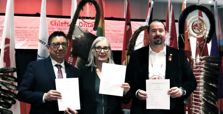 The Ontario region-specific final Child Welfare agreement is worth $8.5 billion over nine years beginning in 2025-26. The deal was signed last week by Nishnawbe Aski Nation Grand Chief Alvin Fiddler, (left), Minister of Indigenous Services Canada Patty Hajdu and Ontario Regional Chief Abram Benedict who hold the signed Ontario Final Agreement. It was signed at a Special Chiefs Assembly in Toronto Feb. 26. (Supplied Photo)