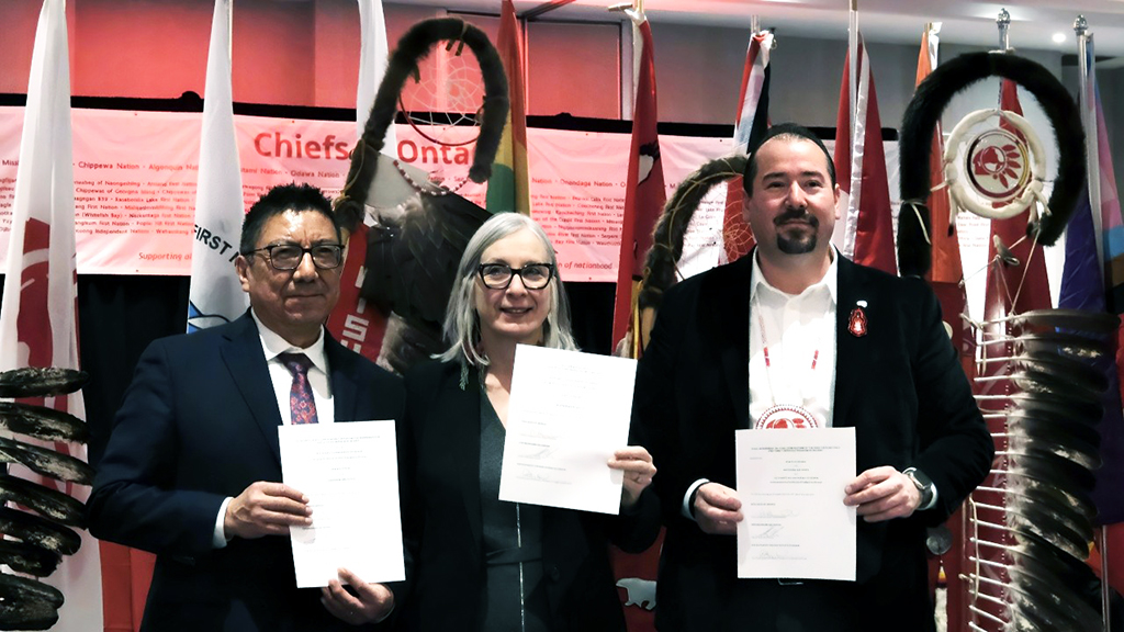 The Ontario region-specific final Child Welfare agreement is worth $8.5 billion over nine years beginning in 2025-26. The deal was signed last week by Nishnawbe Aski Nation Grand Chief Alvin Fiddler, (left), Minister of Indigenous Services Canada Patty Hajdu and Ontario Regional Chief Abram Benedict who hold the signed Ontario Final Agreement. It was signed at a Special Chiefs Assembly in Toronto Feb. 26. (Supplied Photo)