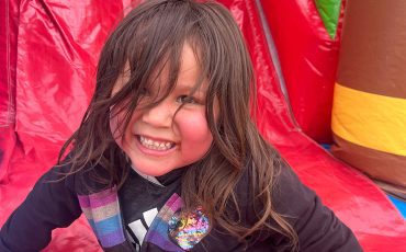 Four-year-old Makenzie Montour screeched with delight as she went down the “big” bouncy slide at Chiefswood Park on May 8 as part of an annual barbecue hosted by SNGRDC.