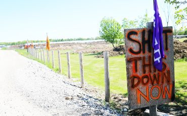Signs and flags line the property and entrance. (Photos by Jim C. Powless)