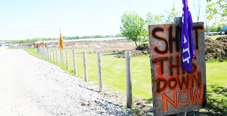 Signs and flags line the property and entrance. (Photos by Jim C. Powless)