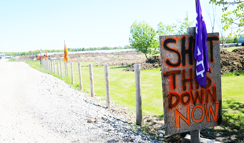 Signs and flags line the property and entrance. (Photos by Jim C. Powless)