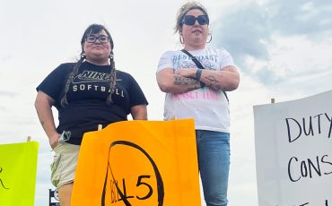 Mississaugas of the Credit First Nation Councillor, Ashley Sault, left, and Jai King-Green posted signage for commuters caught in Hagersville’s Friday afternoon slowdown to raise awareness on Premier Doug Ford’s Bill 5 “Protecting Ontario by Unleasing Our economy Act” just as First Nation leadership from across Ontario rallied outside Queen’s Park in Toronto Monday citing the Premiers’ move as a direct threat to the lands, jurisdiction, and sovereignty of First Nations. (Photo by Tara Lindemann)