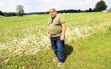 Landwner John Curley is caught with renting out his farm land only to find it was used as a testing site. (Photo by Jim C. Powless)