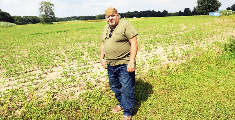 Landwner John Curley is caught with renting out his farm land only to find it was used as a testing site. (Photo by Jim C. Powless)