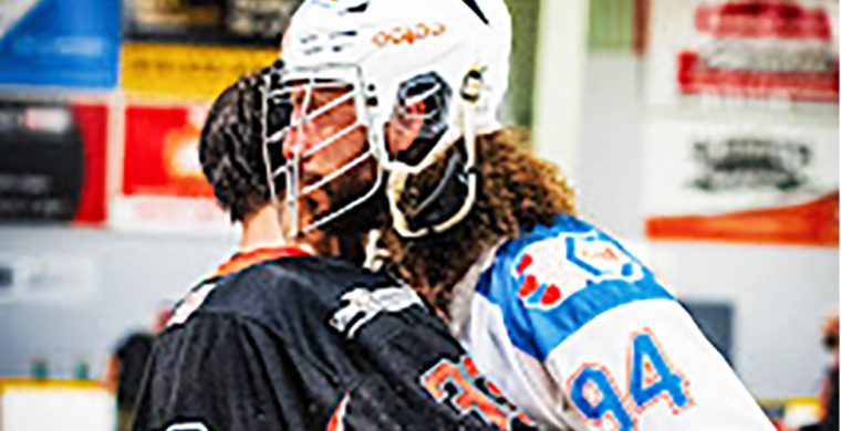 Six Nations Chiefs' defender Tyson Bell (white jersey) hugs an opponent from the Owen Sound North Stars following his team playoff series sweep on Saturday. Photo by Darryl Smart.