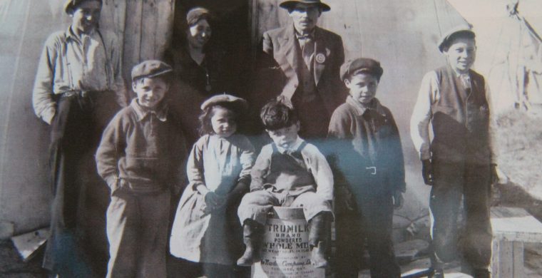 This faded historical photo features my grandfather James Kataquapit who was Chief of Attawapiskat in 1945. Here we see him standing with a hat and pin signifying his leadership. His wife Janie Kataquapit is standing at the door. Chief Kataquapit was also a veteran of the First World War. From L-R are his children: Thomas, Marius, Celine, David, Gabriel and Alex. Missing are brothers George and Leo. (Photo supplied by Kataquapit family )