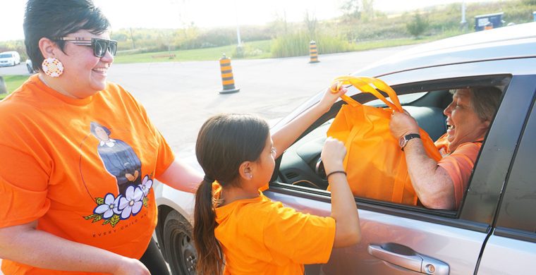 Darlene Powless had a big smile for the Six Nations free family pack giveaway marking Orange Shirt Day at Six Nations. Volunteers of all ages, including Elected Chief Sherri-Lyn Hill, were on hand to give out the packages to residents (Photo by Jim C. Powless)