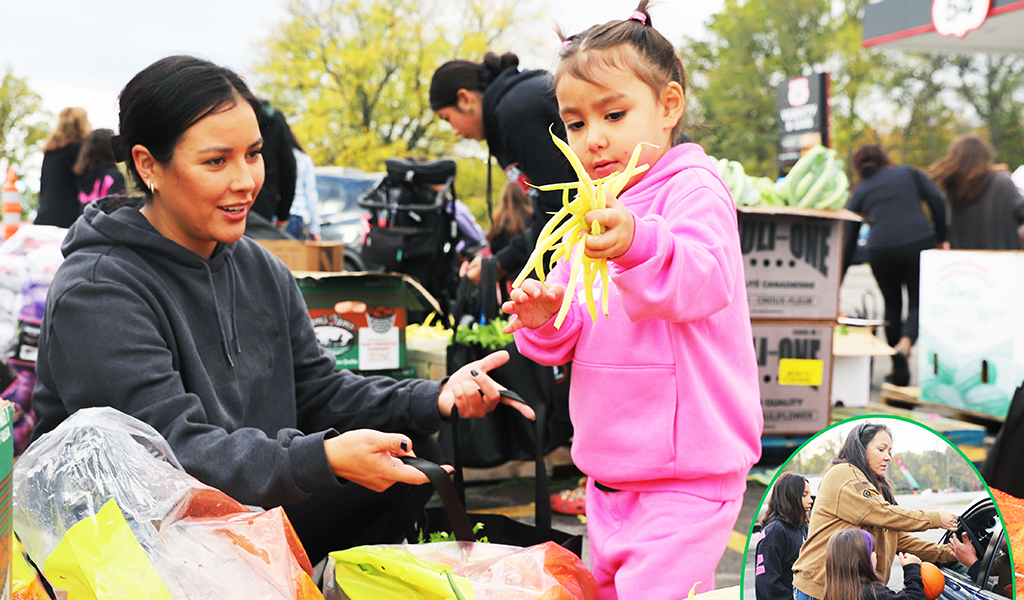 It’s all about family. Route 54 Variety owner Kris Hill’s annual Harvest food give-away fed over 700 families. Volunteers and family, like daughter Markie Styres and her four-year-old daughter Willow, filled bags of food placed in cars by Kris Hill and two more granddaughters. (Photo by Jim C. Powless)