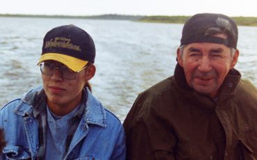 Xavier Kataquapit with his father Marius Kataquapit in their family freighter canoe in the fall of 1996 at the mouth of the Attawapiskat River on James Bay. Photo provided by X Kataquapit.