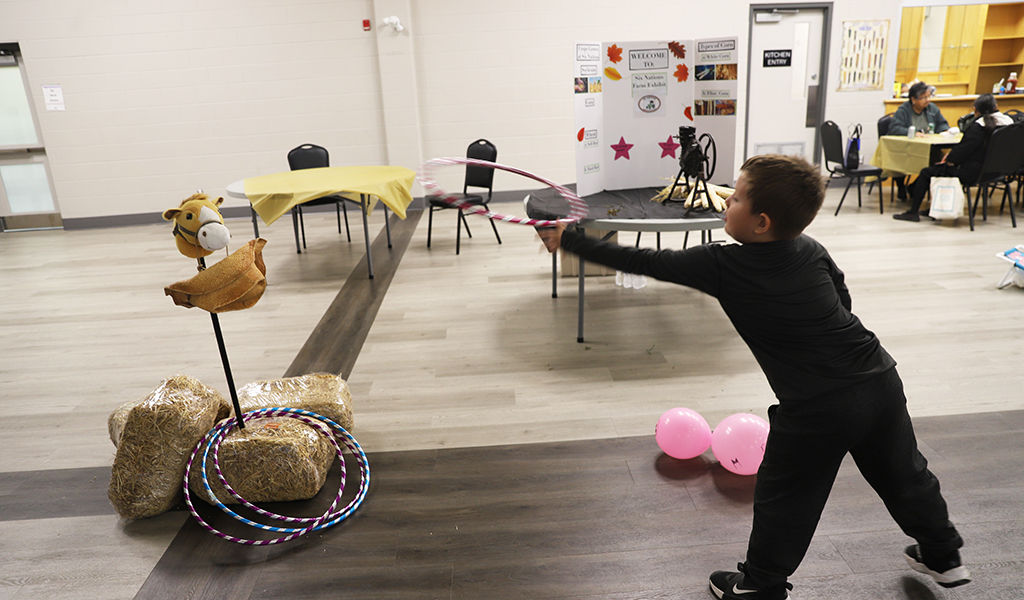 Wrangling the cow. The Six Nations Farmers’ Association had a room full of fun hands on displays at their annual Agricultural Day Friday, including how to wrangle cattle! See page 4 for more. (Photo by Jim C Powless)
