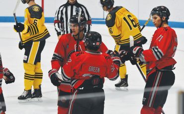 Members of the Six Nations Ironmen celebrate a goal on Sunday. Pictured are goalscorer Mitch Green, as well as Theo Hill on left, and Brenden Anderson on right. (Photo by Honee Anderson).