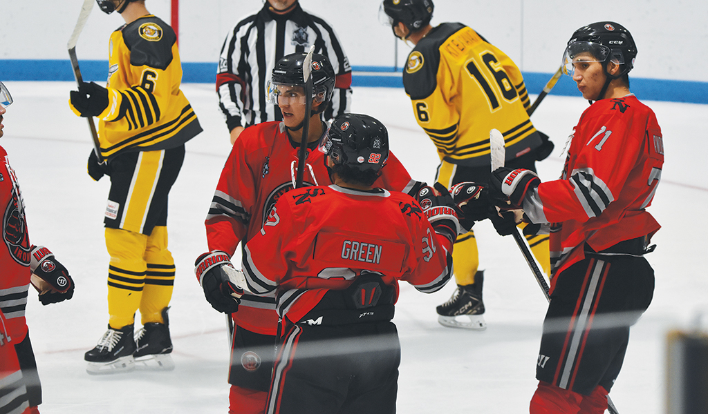 Members of the Six Nations Ironmen celebrate a goal on Sunday. Pictured are goalscorer Mitch Green, as well as Theo Hill on left, and Brenden Anderson on right. (Photo by Honee Anderson).