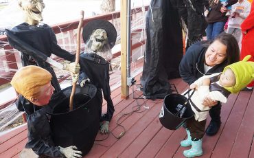 Forget the witches, U.S. President Trump appearing at Turtle Island News’ annual Haunted Porch was enough to startle this little one back into mom’s arms!