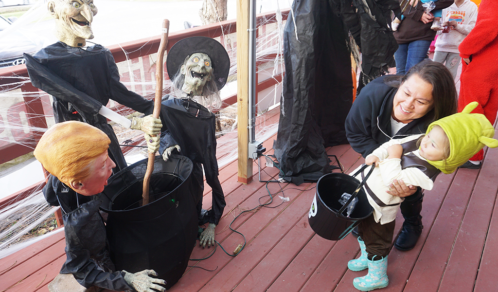 Forget the witches, U.S. President Trump appearing at Turtle Island News’ annual Haunted Porch was enough to startle this little one back into mom’s arms!