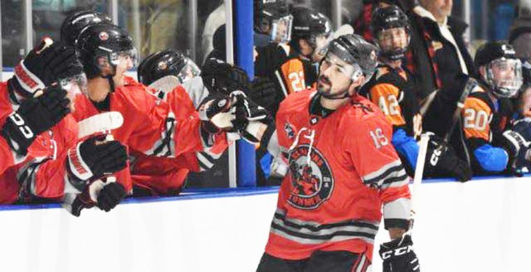 Todd Ratchford (#19) celebrates a goal with his Six Nations Ironmen teammates in their Dec. 21 game. Photo by Honee Anderson.