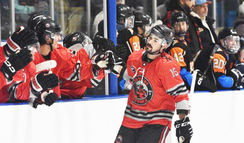 Todd Ratchford (#19) celebrates a goal with his Six Nations Ironmen teammates in their Dec. 21 game. Photo by Honee Anderson.