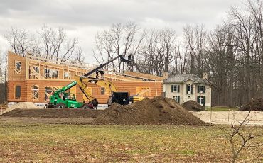 With the historic Pauline Johnson House in the background, work on Six Nations’ new Tourism Information Centre is continuing despite the weather. The huge two-storey structure will also include offices for tourism staff. (Photo by Jim C. Powless)