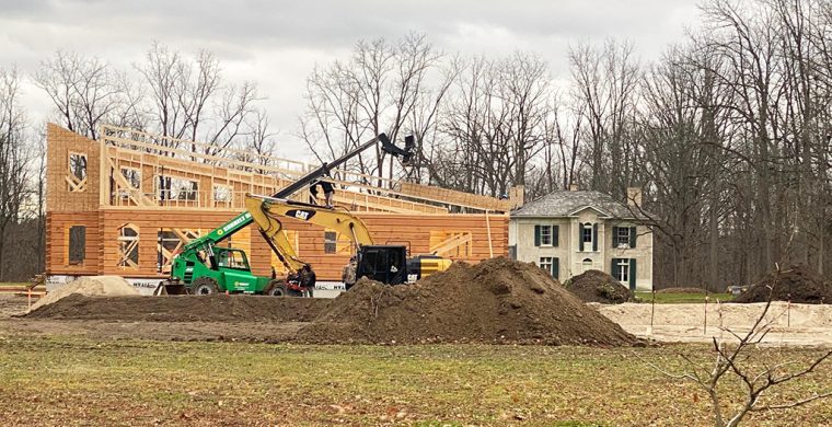 With the historic Pauline Johnson House in the background, work on Six Nations’ new Tourism Information Centre is continuing despite the weather. The huge two-storey structure will also include offices for tourism staff. (Photo by Jim C. Powless)
