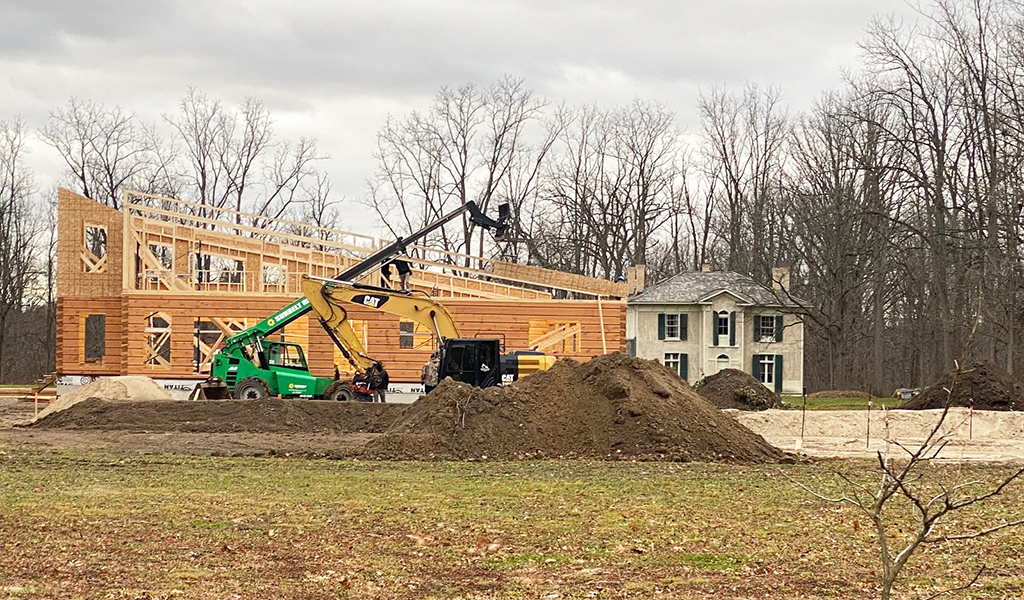 With the historic Pauline Johnson House in the background, work on Six Nations’ new Tourism Information Centre is continuing despite the weather. The huge two-storey structure will also include offices for tourism staff. (Photo by Jim C. Powless)