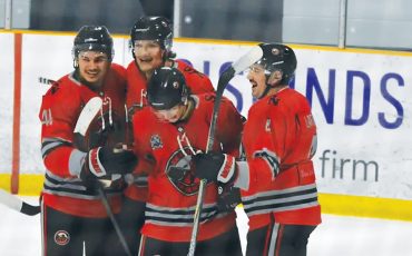 Members of the Six Nations Ironmen celebrate a goal from their Friday game in Strathroy. Photo by Honee Anderson.