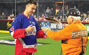 Six Nations member Justin Martin, left, took part in the pre-game smudge ceremony during the Toronto Rock Indigenous Heritage Night. (Photo by Sam Laskaris.)