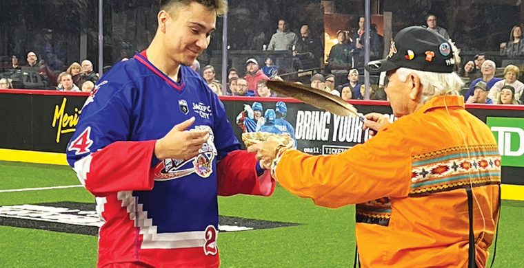 Six Nations member Justin Martin, left, took part in the pre-game smudge ceremony during the Toronto Rock Indigenous Heritage Night. (Photo by Sam Laskaris.)