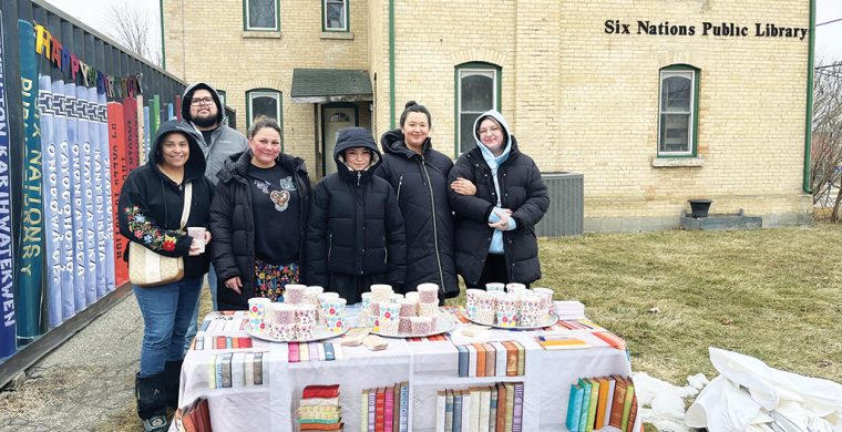 Six Nations librarian, Feather Maracle (second from left) , along with staff and supporters like Dakota Brant (right) marked the public library’s 60th anniversary outside the now closed building. (Photos by Alex Murray)