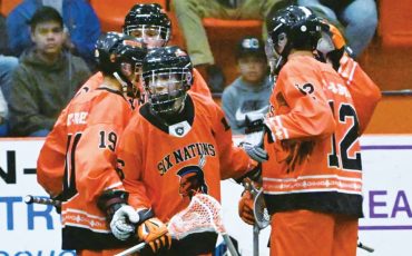 Six Nations Rebels’ captain Chaz Hill (centre of pic with stick) celebrates his goal in the club’s season opener this past Friday. Photo courtesy Six Nations Rebels.